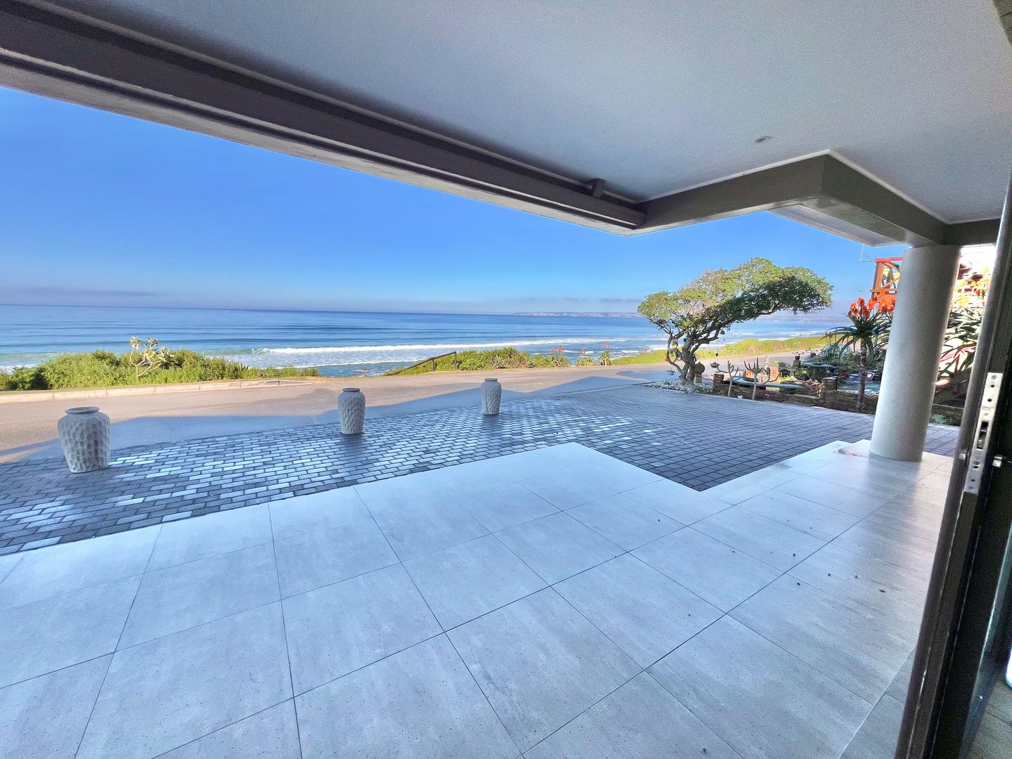 The covered terrace of the bottom unit looking onto the dune and the sea