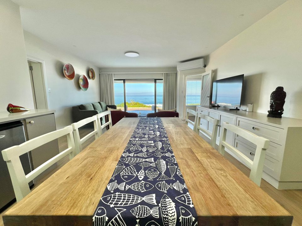 The long table in the bottom unit, with the sea through the glass doors